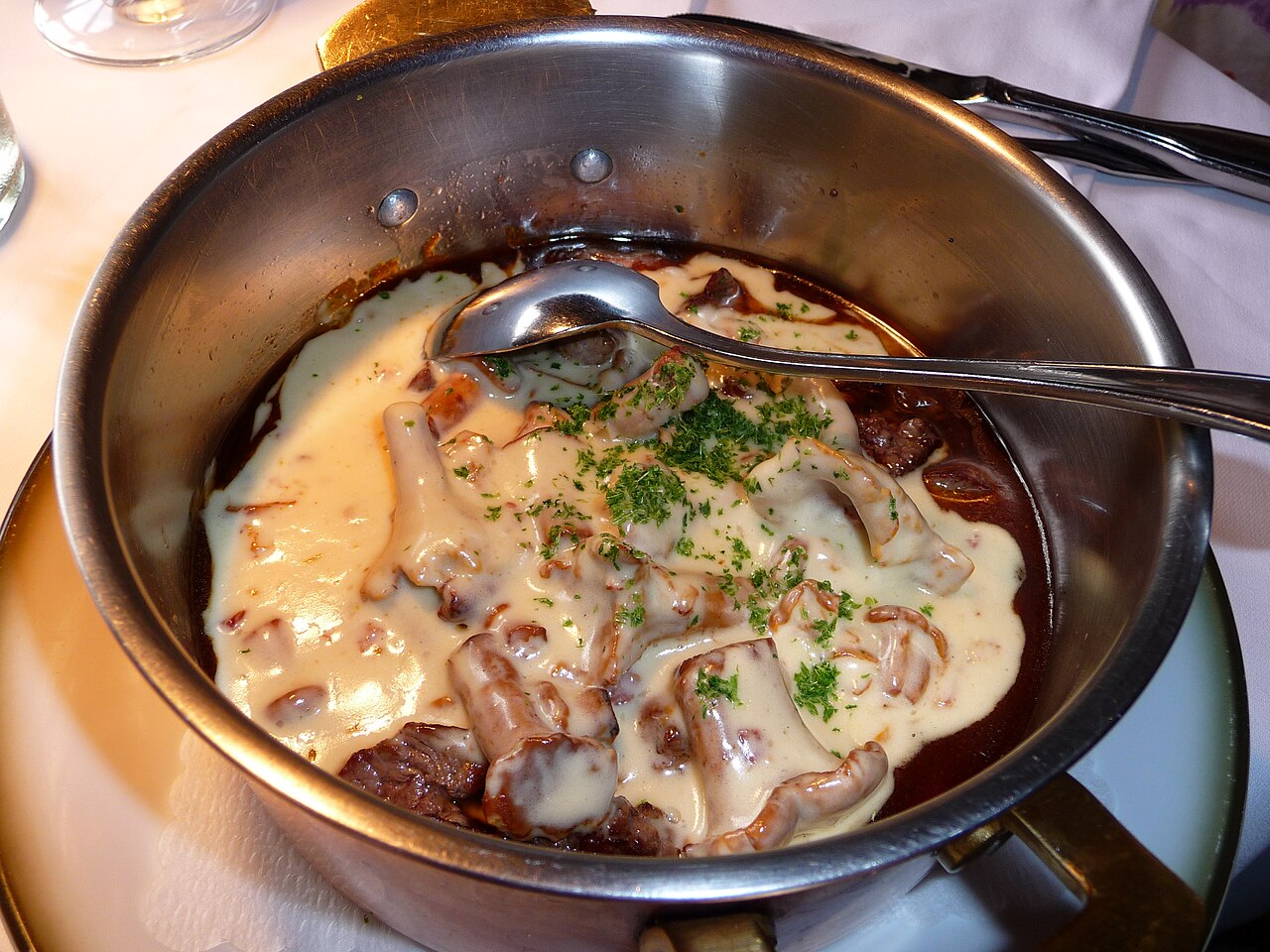 Creamy chanterelle mushroom sauce served with meat and potatoes